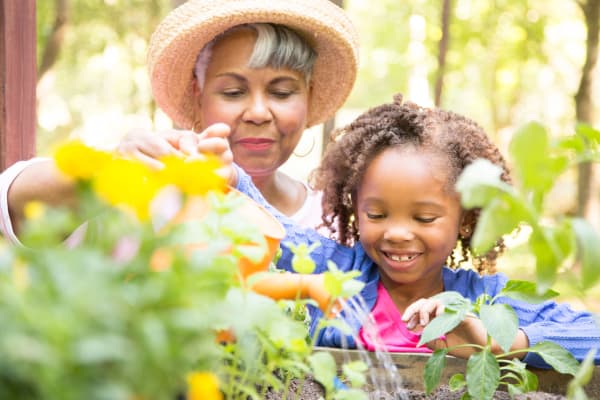 Resident and granddaughter gardening at AgeWell Living