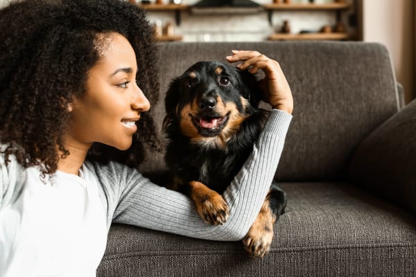 Resident giving her dog some love in their pet-friendly home at Crawford Crossing Apartments in Turner, Oregon