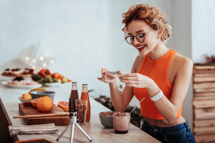 Resident taking a picture of her healthy breakfast in her new home at Uptown Ann Arbor in Ann Arbor, Michigan