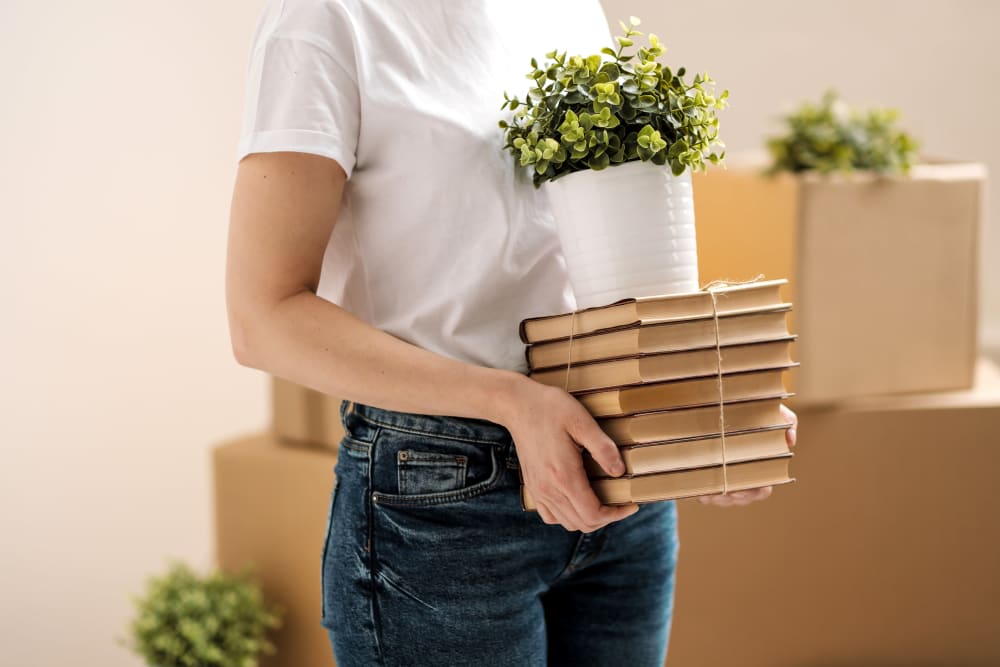 Woman packing her things to be stored in Sherman, Texas at Devon Self Storage