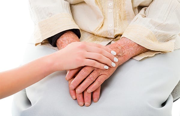 Resident being comforted by a caretaker at The Pearl at Eastside in Greenville, South Carolina