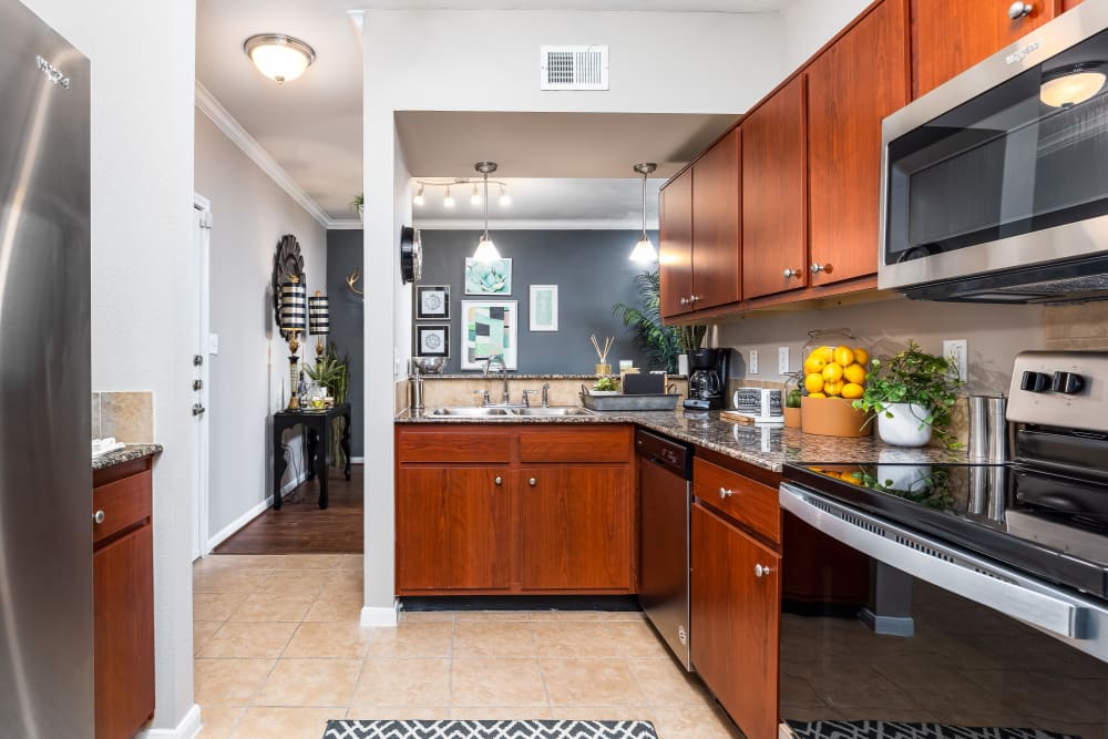 Kitchen with modern appliances at The Abbey at Grande Oaks in San Antonio, Texas