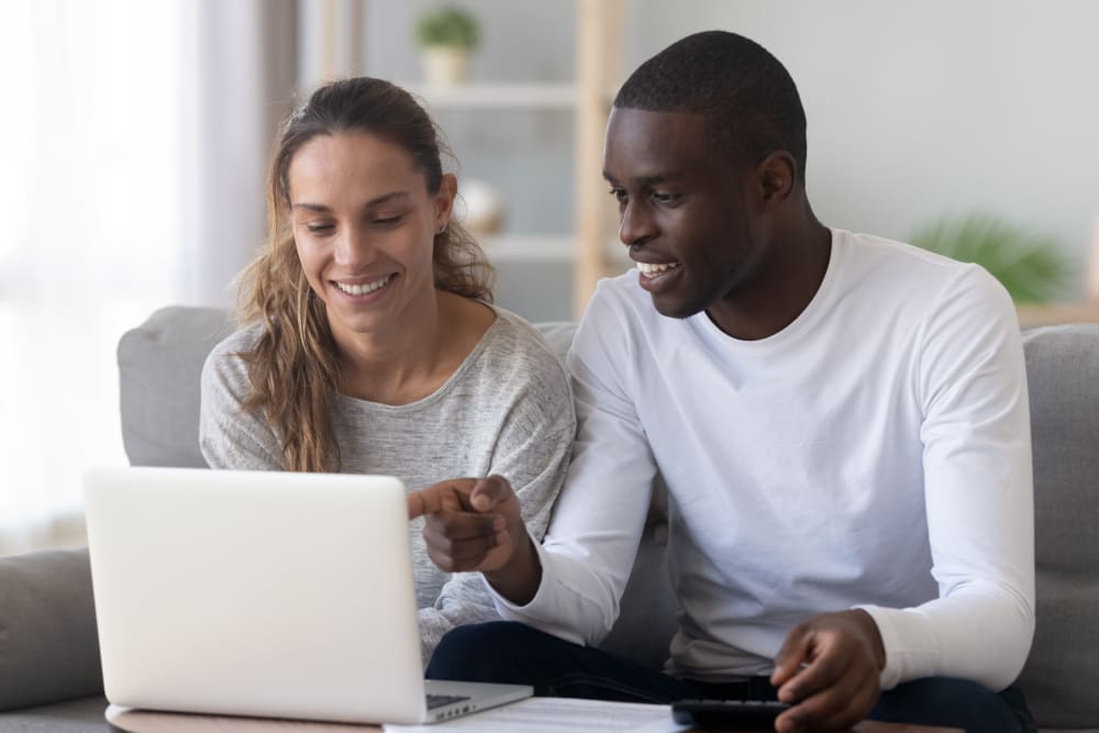 Couple looking at their computer together at Grand Biscayne in Biloxi, Mississippi
