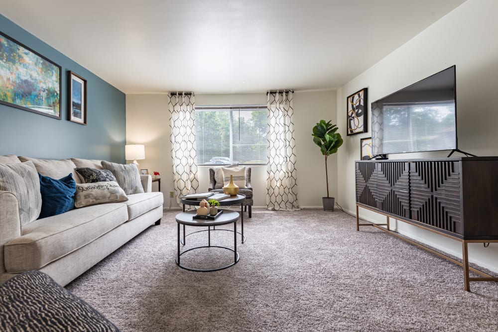 Spacious living room with wall to wall carpeting at High Acres Apartments & Townhomes in Syracuse, New York