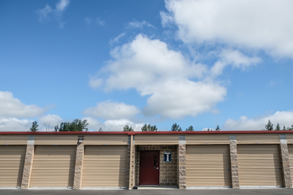 Exterior units with blue sky and clouds at Urban Self Storage Enumclaw - Phase II