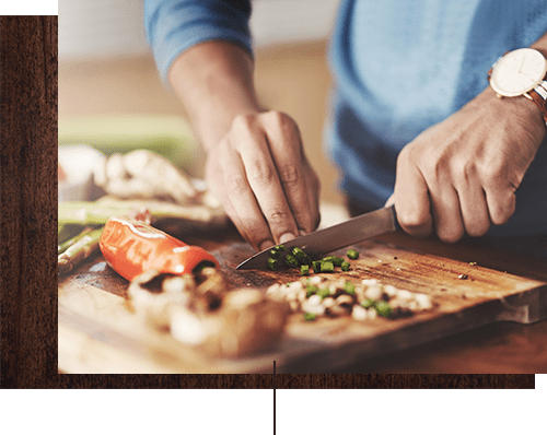 Resident cooking up something delicious in his new home's kitchen at Alicante Apartment Homes in Aliso Viejo, California