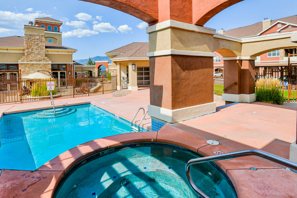 Hot tub and swimming pool at Bella Springs Apartments in Colorado Springs, Colorado