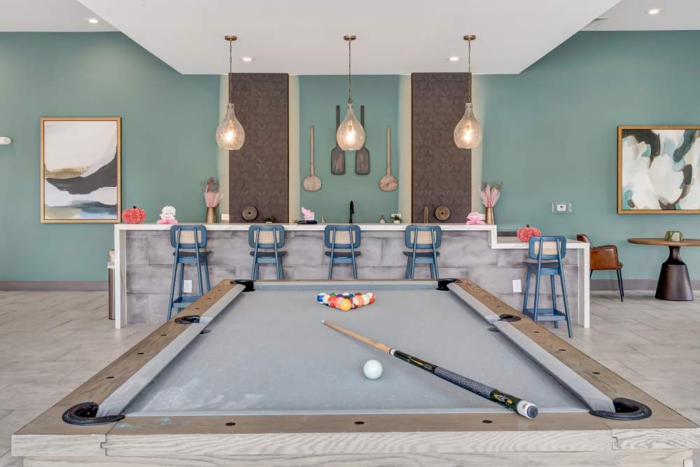 Clubhouse with a pool table at Gibson Flowery Branch | Apartments in Flowery Branch, Georgia