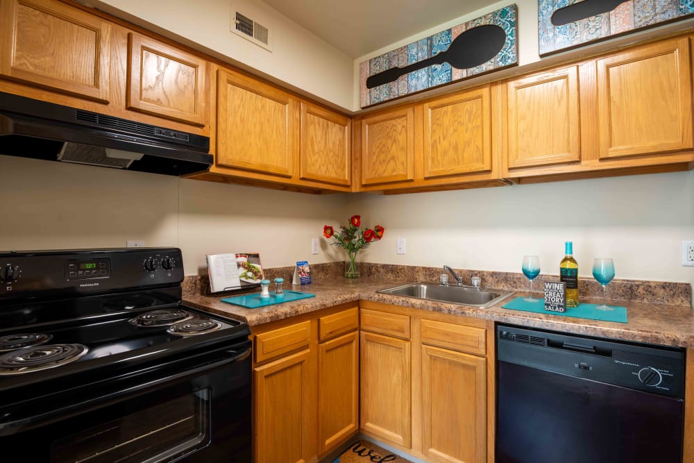 Kitchen with oak cabinets and black appliances