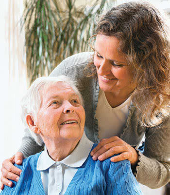 Caretaker helping a resident at West Fork Village in Irving, Texas