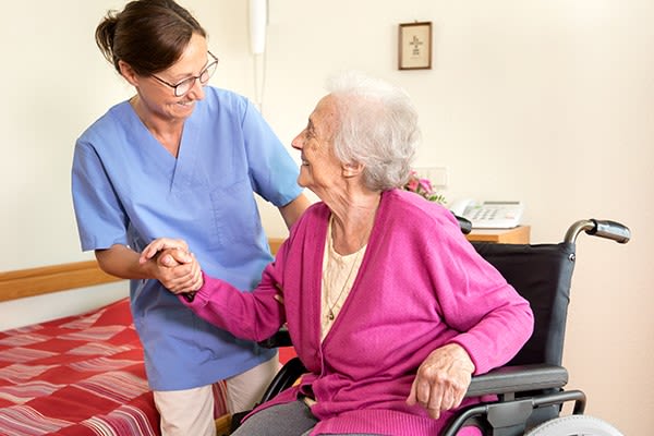 A caretaker assisting a resident at Heritage Senior Living in Blue Bell, Pennsylvania