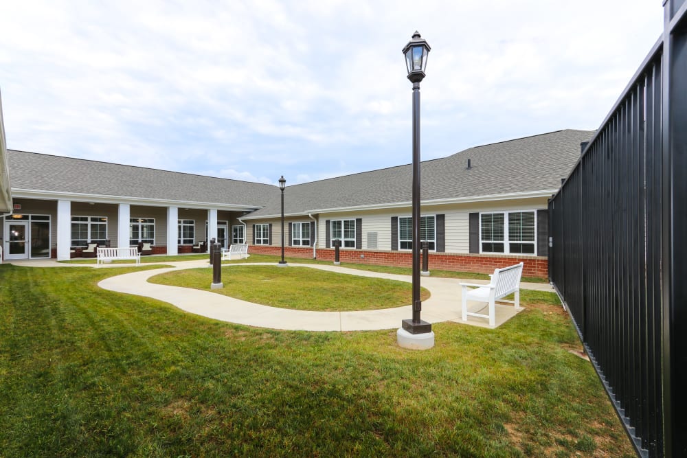 A paved walkway around the courtyard at The Harmony Collection at Roanoke - Memory Care in Roanoke, Virginia