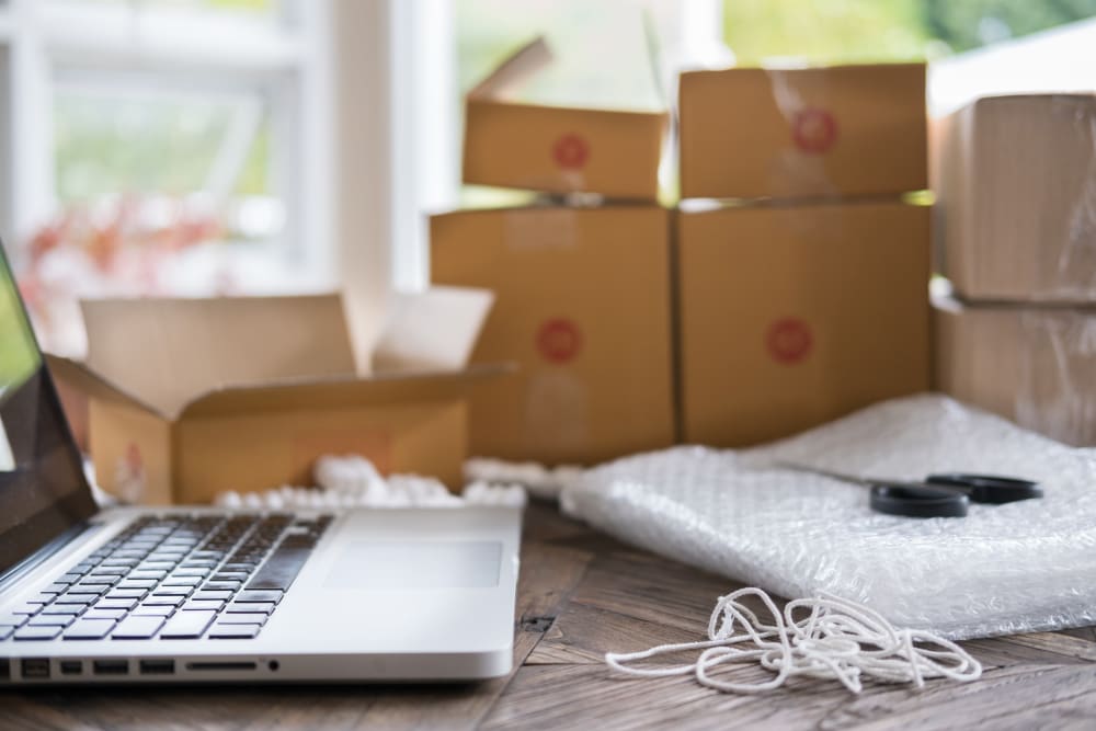 Open laptop in front of boxes and packing supplies near AAA Self Storage in Chatsworth, California