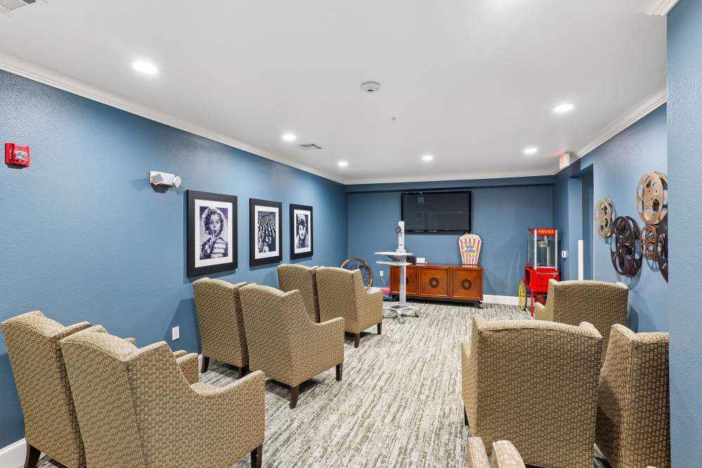 A large room with television, a couch, a chair, and a coffee table at Isle at Watercrest Bryan in Bryan, Texas