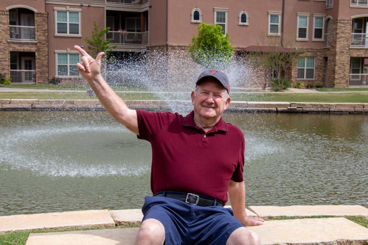 Resident throwing up a guns up at Raider Ranch in Lubbock, Texas