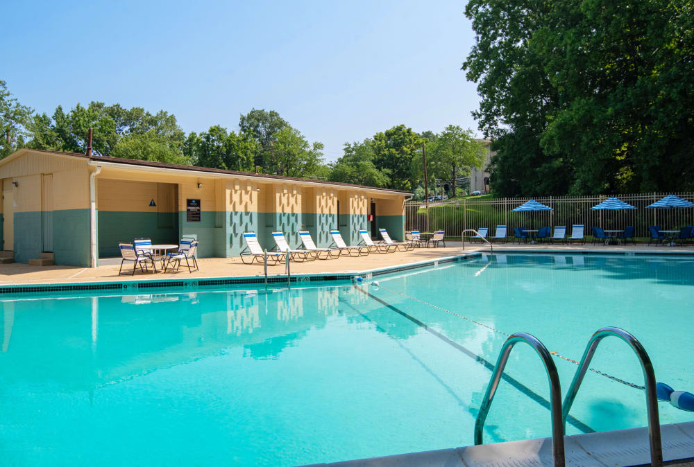 Swimming pool surrounded by lounge chairs at Harbor Place Apartment Homes in Fort Washington, Maryland