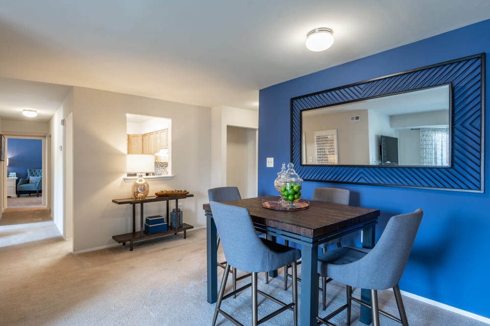 Dining area in model apartment with wall to wall carpeting at The Willows Apartment Homes in Glen Burnie, Maryland