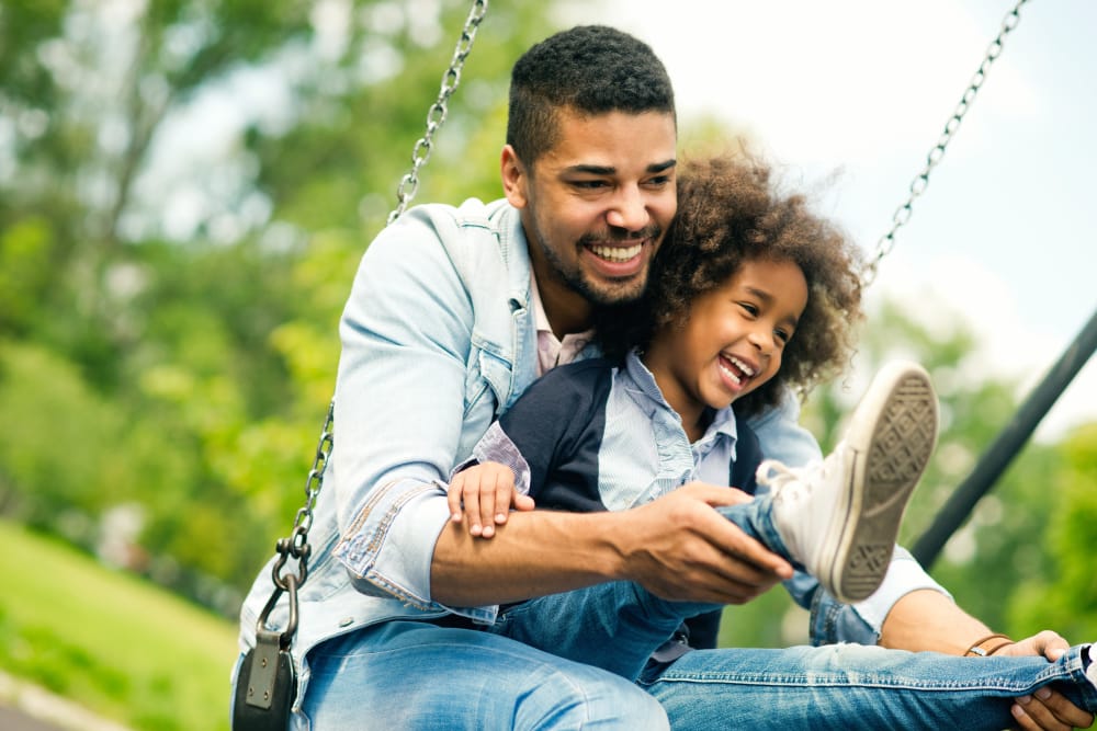Family having fun at a park near Carmichael Cove Apartments in Carmichael, California