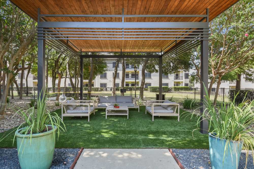Community outdoor seating area with couch, chairs and coffee table at Sullivan in Austin, Texas 