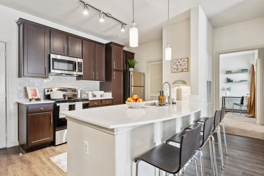 Kitchen with wooden cabinetry and countertops at Midtown 905 in Denton, Texas