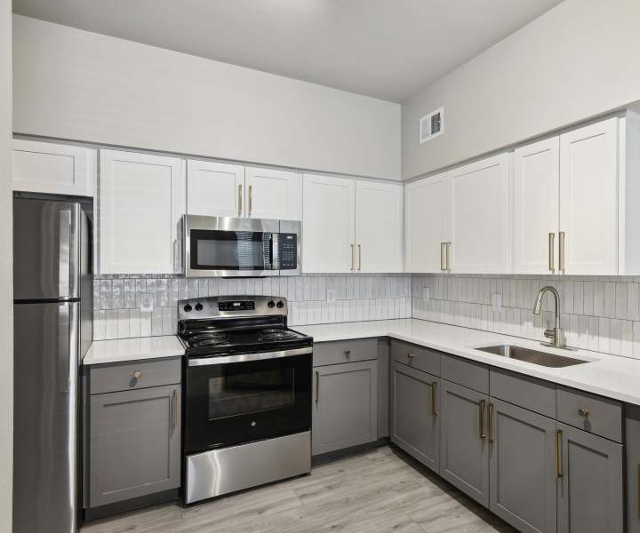 Kitchen with white and grey color cabinet at Collier in Pflugerville, Texas
