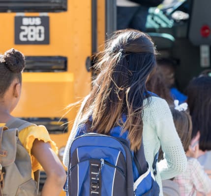 Kids getting on the school bus near Bayfair Apartment Homes in San Lorenzo, California