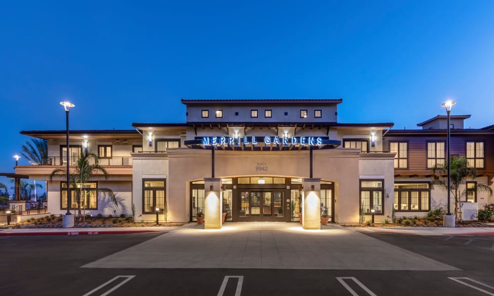 Evening view of front entrance to Merrill Gardens at Rancho Cucamonga in Rancho Cucamonga, California. 