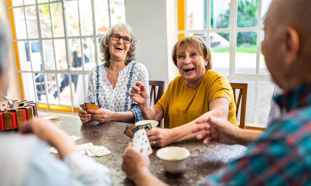 Residents playing a card game at Ativo Senior Living of Yuma in Yuma, Arizona.