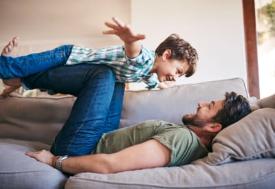 Resident father and son spending some quality time together in their new home at Signal Pointe Apartment Homes in Winter Park, Florida
