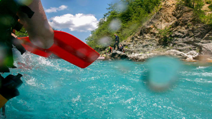 person kayaking through water
