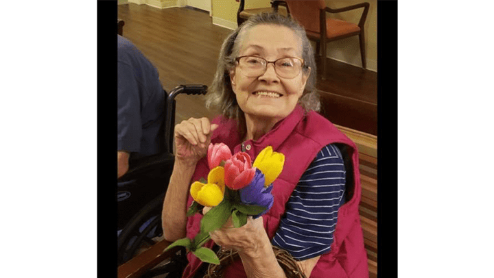 Greenridge Place resident holding colorful flowers