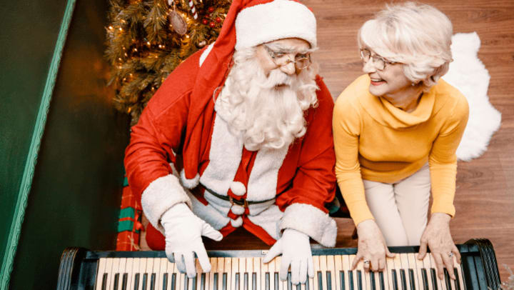 an old lady playing piano with santa 