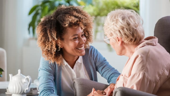 a woman and an old woman smiling at each other 