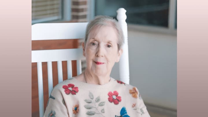 Headshot of Donna Hilson seated on a patio in a large white rocker