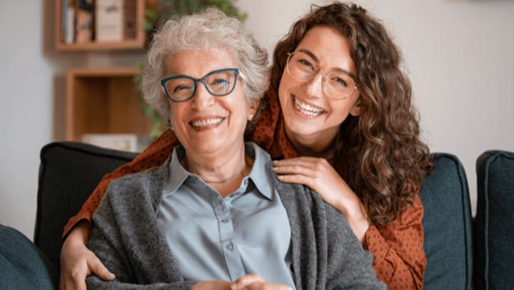 senior woman smiling with her caregiver