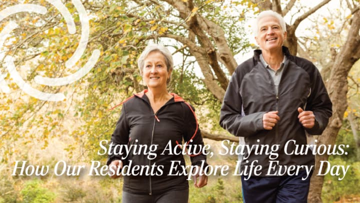 Two smiling older adults jog together outdoors on a tree-lined path, dressed in athletic wear. Text overlay reads: “Staying Active, Staying Curious: How Our Residents Explore Life Every Day