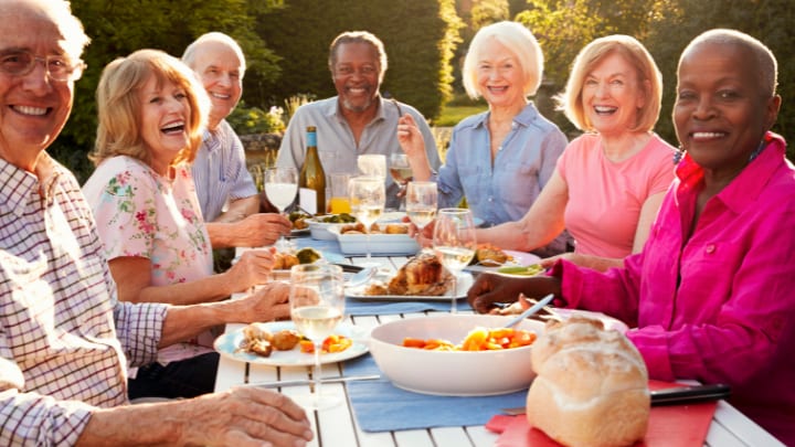 a group of seniors having dinner