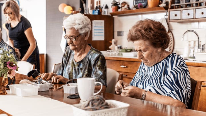 two senior ladies doing sensory activities together 