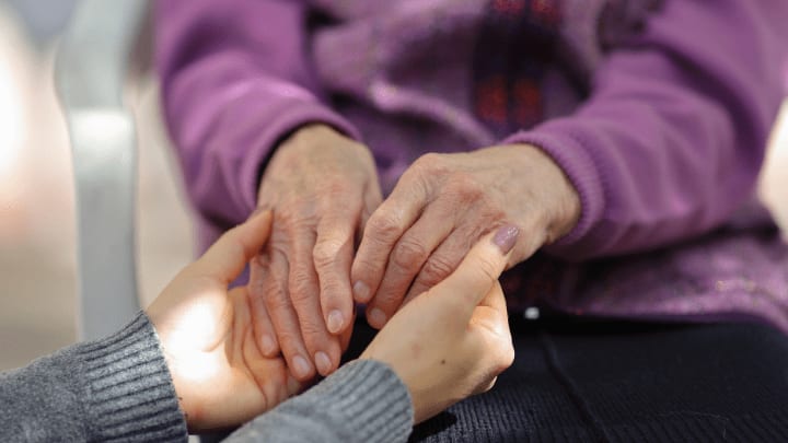 old woman and girls holding hands