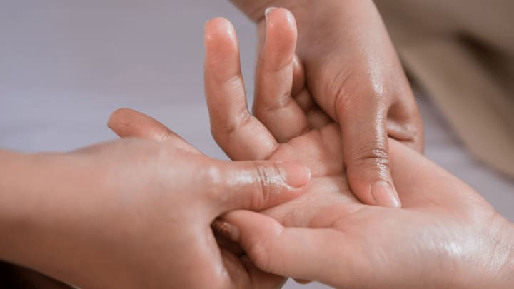 an older adult receiving hand therapy