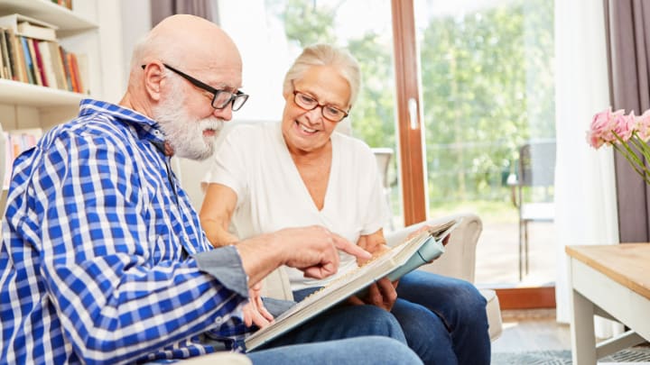 a couple of seniors reading together 