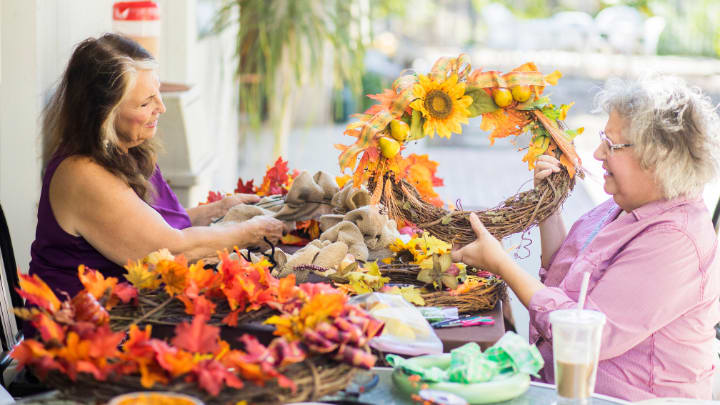 two ladies working together on a flower arrangement