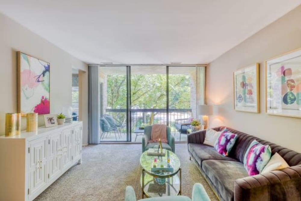 Model Living room with floor to ceiling windows at The Timbers at Long Reach Apartments in Columbia , Maryland