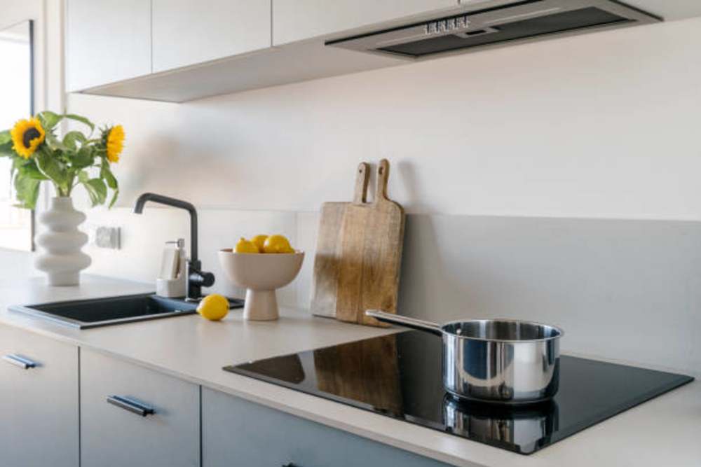 Resident cooking in the kitchen with energy-efficient appliances at Canyon Townhomes in Phoenix, Arizona