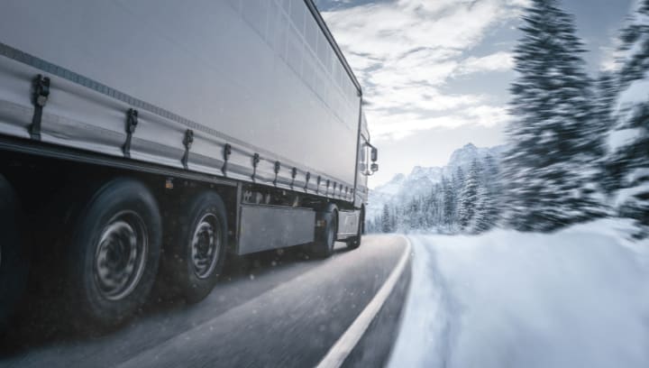 Moving truck driving through snowy winter road symbolizing reliable winter moving and secure self storage services in Portland Oregon