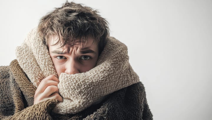 Person bundled in a thick scarf staying warm in cold weather, representing winter preparedness and climate-protected self storage options in Portland Oregon