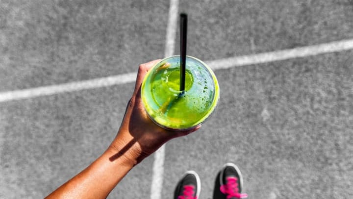 Resident drinking a green smoothie near Olympus Waterford in Keller, Texas