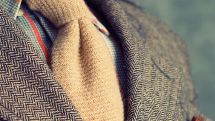 Closeup of retro vintage twill jacket with woolen necktie