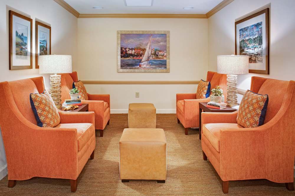 Sitting area with armchairs and decorative accents at Glenncrest at Johns Creek in Johns Creek, Georgia