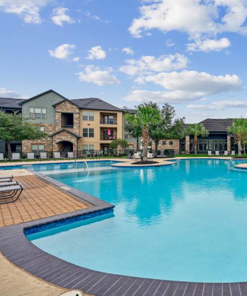 Swimming pool with lounge chairs at Barron Park in Pearland, Texas